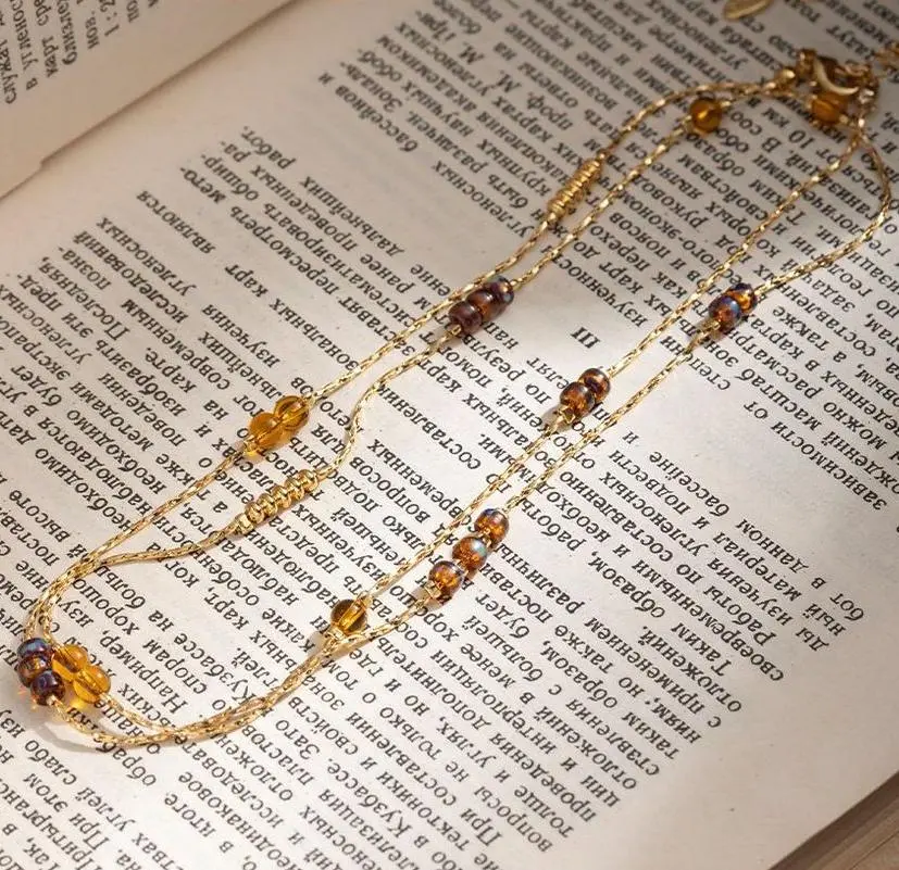 LIVKE gold-plated adjustable tri-bead necklace styled as double layers with minimalist pendants, showing day-to-night versatility