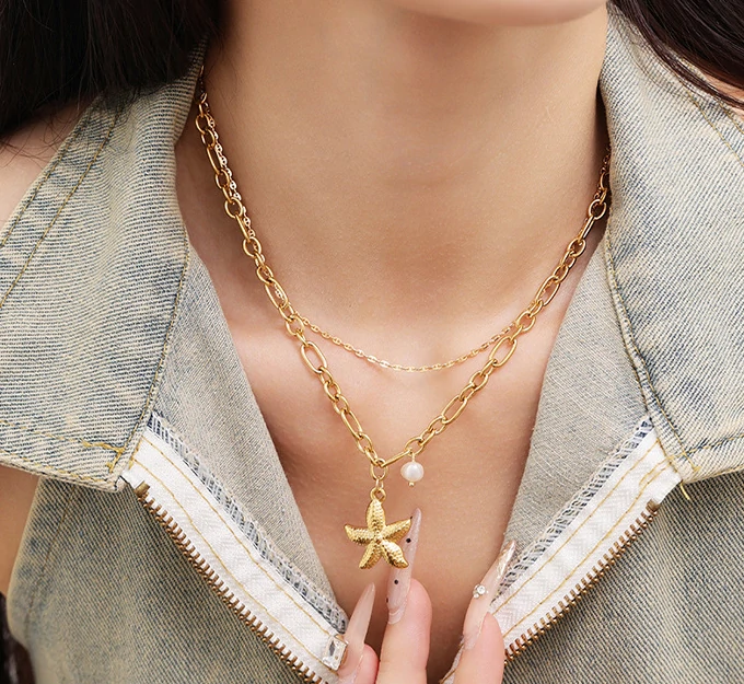 livke-tumbled-shell-necklace-california-beach (13) Natural tumbled shell pendant on 18K gold-plated chain styled with linen shirt and jeans at beachside café