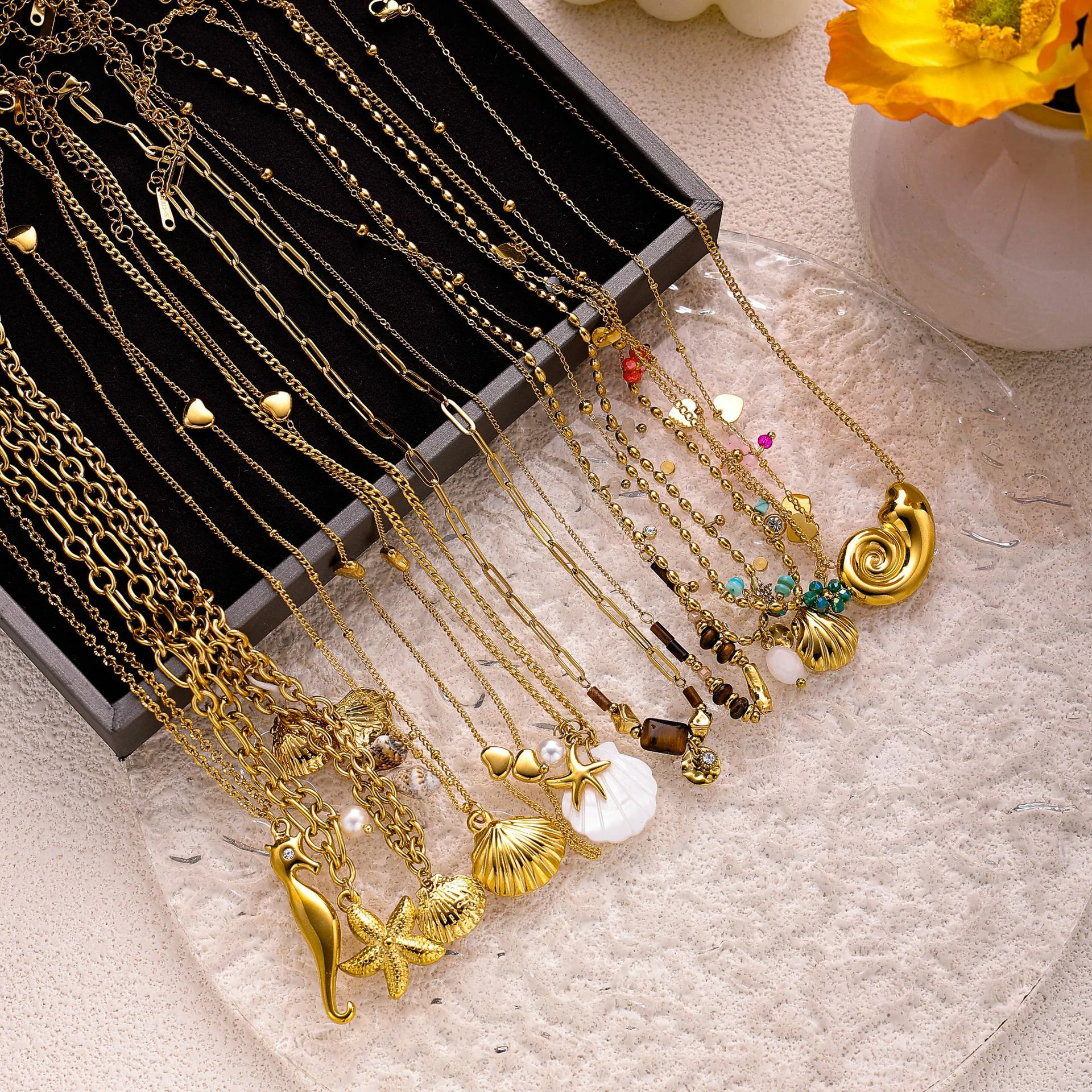 livke-tumbled-shell-necklace-california-beach (6) Natural tumbled shell pendant on 18K gold-plated chain styled with linen shirt and jeans at beachside café