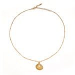 Coastal Minimalist Necklace 1 Natural tumbled shell pendant on 18K gold-plated chain styled with linen shirt and jeans at beachside café
