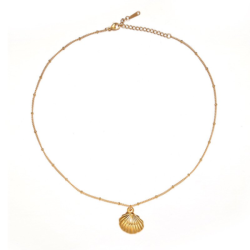 livke-tumbled-shell-necklace-california-beach.jpg (11) Natural tumbled shell pendant on 18K gold-plated chain styled with linen shirt and jeans at beachside café