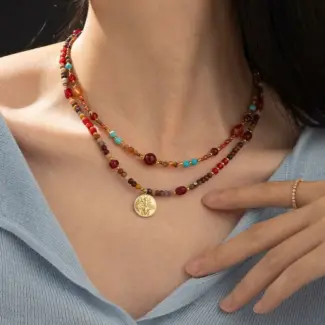 LIVKE surgical steel necklace with red agate and turquoise beads, layered with minimalist chains for boho-chic styling