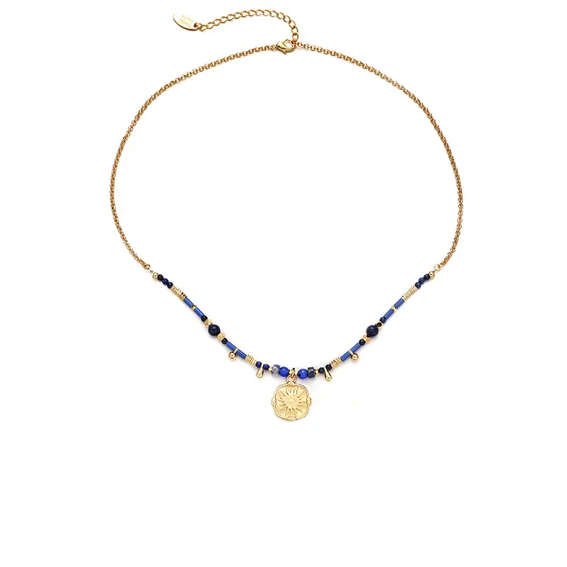 LIVKE’s gold-plated brass necklace featuring a lapis lazuli pendant, styled with a white linen blouse for effortless elegance.