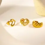 Vintage Love Signet Ring 7 Woman wearing LIVKE gold love signet ring while holding cappuccino in Parisian café, showcasing stackable jewelry styling