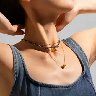 LIVKE 18K gold-plated layered necklace with colored pearls and zirconia, styled with linen and seashells for coastal minimalist aesthetic