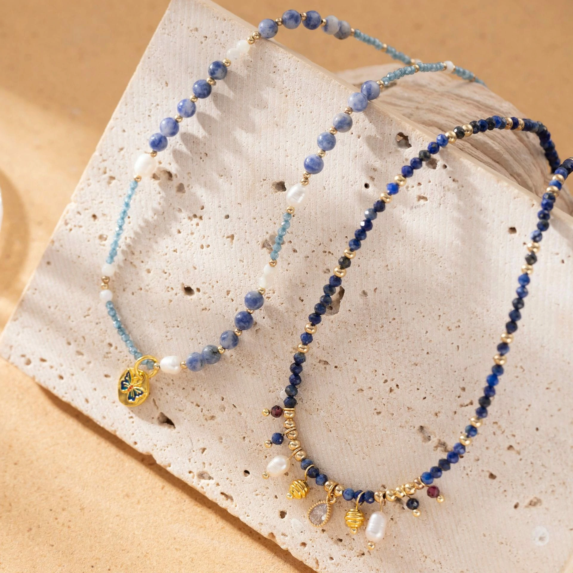 LIVKE 18K gold-plated layered necklace with colored pearls and zirconia, styled with linen and seashells for coastal minimalist aesthetic