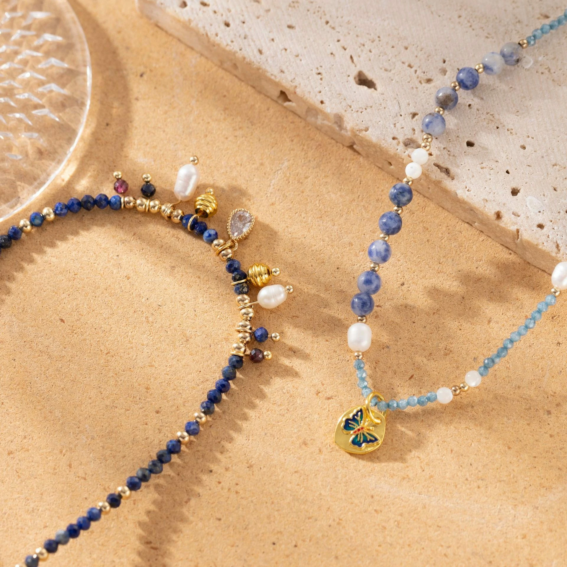 LIVKE 18K gold-plated layered necklace with colored pearls and zirconia, styled with linen and seashells for coastal minimalist aesthetic