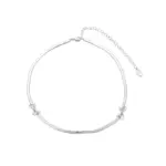 White Gold Plated Bow Necklace 1 Bride wearing LIVKE white gold bow necklace with off-shoulder wedding dress, showcasing elegant bridal jewelry under sunset light