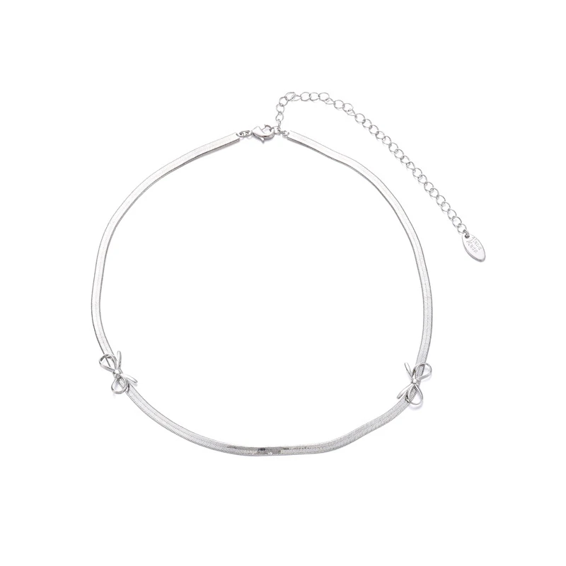 livke-white-gold-bow-necklace-bridal-luxury-layering (2) Bride wearing LIVKE white gold bow necklace with off-shoulder wedding dress, showcasing elegant bridal jewelry under sunset light