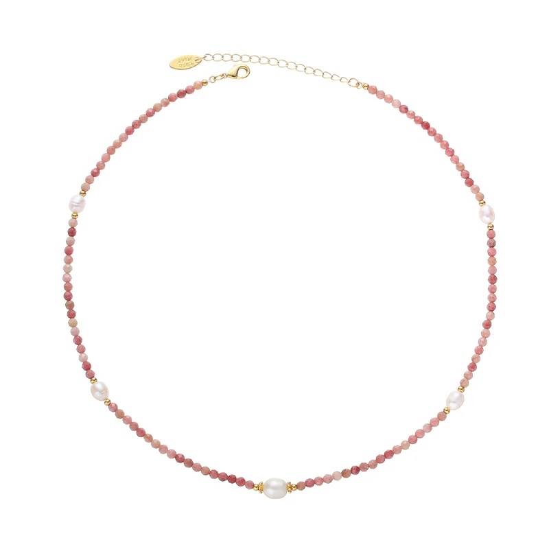 Close-up of LIVKE Y2K mystic necklace with raw amethyst, pearl, and cubic zirconia on model with holographic eyeshadow, showcasing edgy boho jewelry