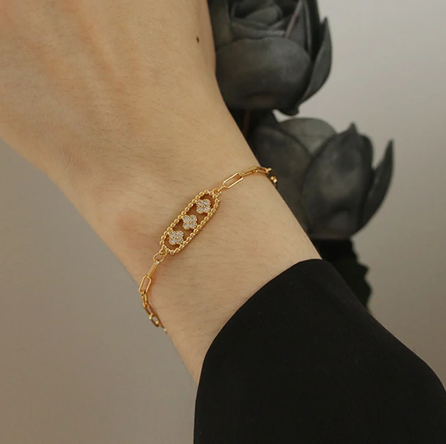 Gold chunky chain bracelet with crystal-encrusted floral pendant, perfect for statement jewelry lovers and art deco inspired accessories