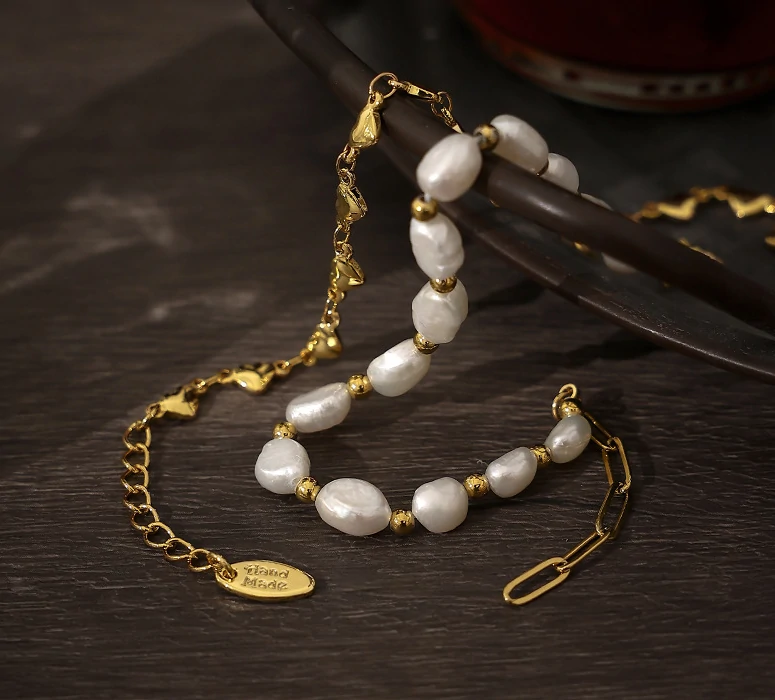 18K gold plated chain bracelet with twelve engraved heart charms, blending Edwardian elegance with modern minimalist jewelry trends