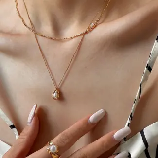 Delicate gold and silver chain set with iridescent shell pendants, perfect for beach weddings and minimalist jewelry lovers